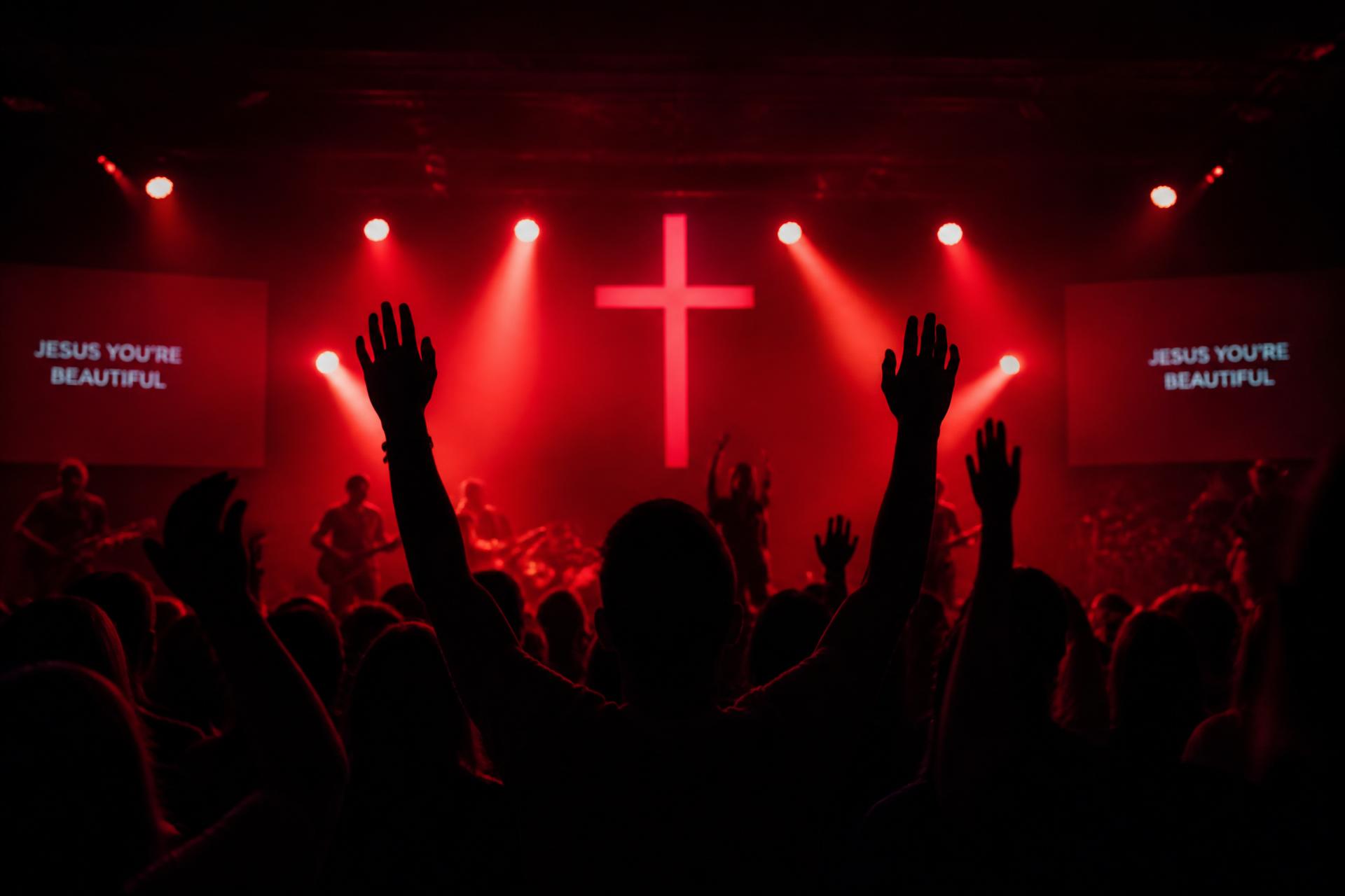 Congregation worshipping under red stage lights at CCI Yaba
